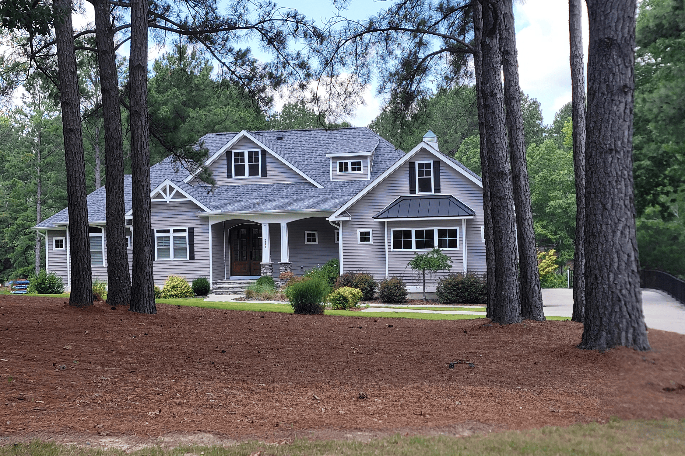 House surrounded by trees and greenery.
